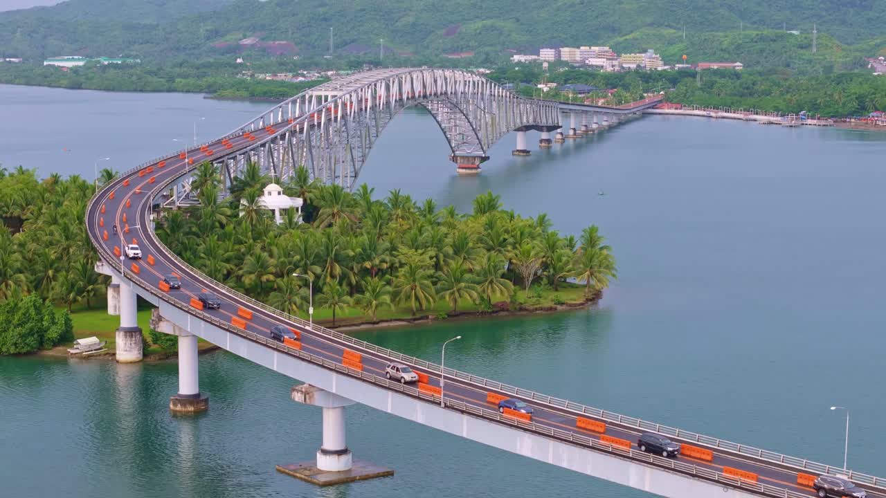 Static drone shot of San Juanico Bridge connecting Leyte and Samar. Calm water, tropical coastline, and smooth afternoon light.