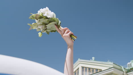 Hand-holding-a-bridal-bouquet