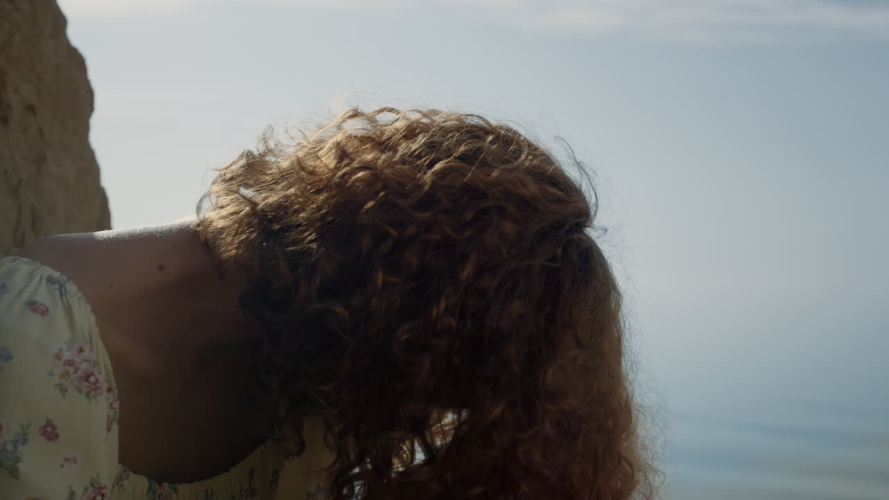 Positive girl laughing looking camera at blue sea close up. Portrait happy woman