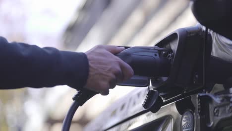 plugging in an ev charger to an electric car