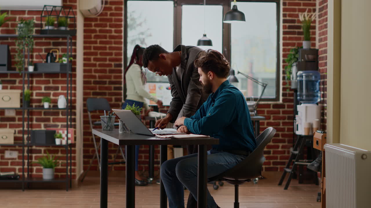 Team of coworkers analyzing data charts and graphs on papers