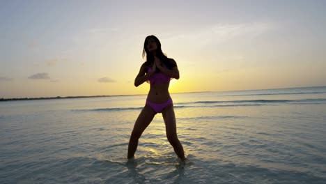 barefoot ethnic girl carefree dancing on tropical beach