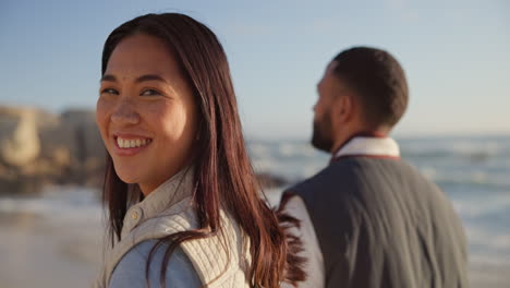 walking, beach and face of couple holding hands by