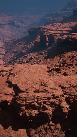 a barren landscape on mars, with red rocks and canyons