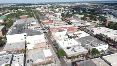 aerial arching over east 8th avenue in ybor city, in tampa, florida, arch ends with a distant view of port tampa and the ybor channel