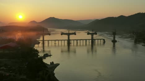 Bridge Construction Under Sunset on the Mekong River