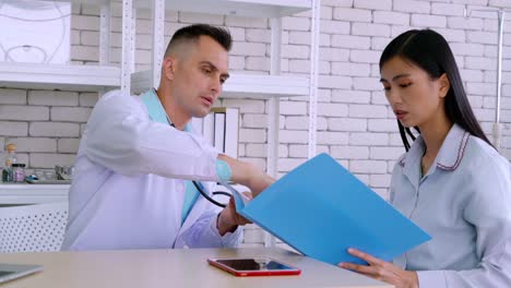 doctor in professional uniform examining patient at hospital