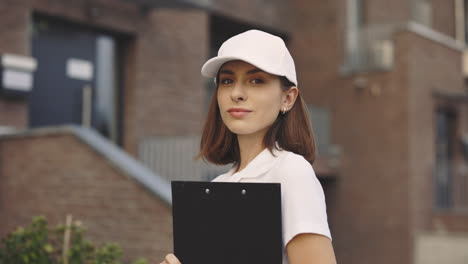 woman holding clipboard outside