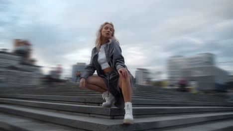 Confident-woman-posing-cityscape-at-evening-street-in-downtown-district.