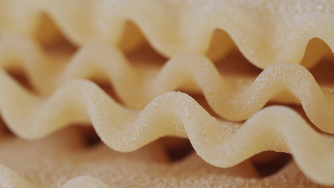 Close-up of Uncooked Wavy Lasagna Pasta Noodles