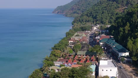 aerial drone footage of white sand beach village, koh chang, thailand. capturing sunny morning views of the coast and tropical scenery