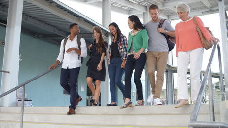 Tilt-shot-of-a-group-of-teachers-walking-down-school-steps