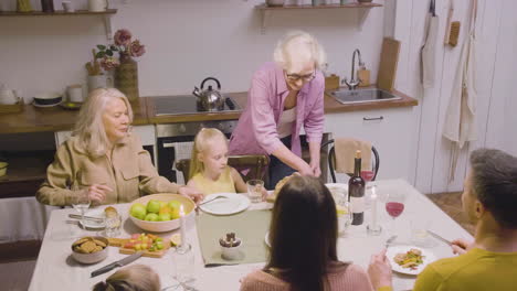 top view of family sitting at the table during dinner at home 1