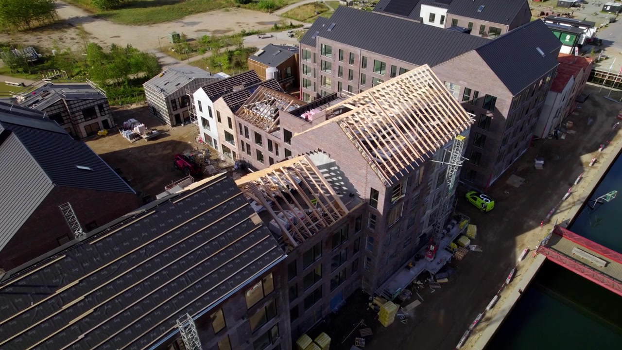 Luftfoto av moderne leilighetsbygg under bygging nær en havn i Danmark