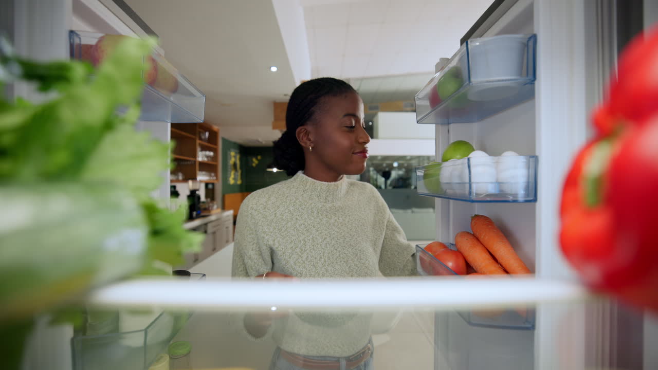 Woman taking food from refrigerator