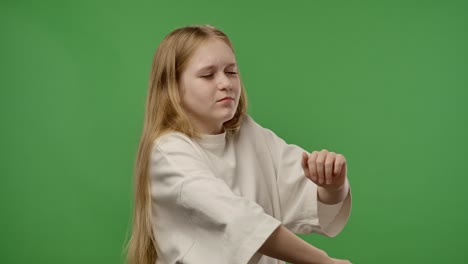 teenage girl posing in front of green screen