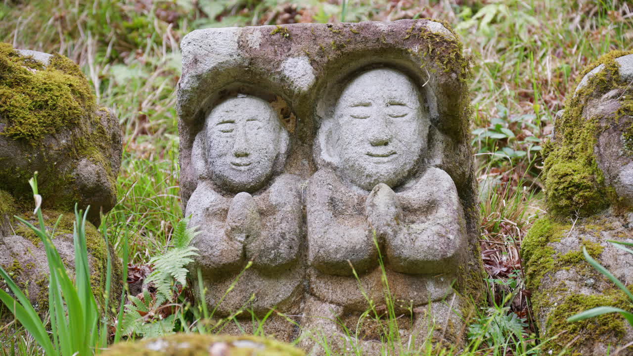 Moss-covered arhat statues covering the hillside around the temple grounds at the Otagi Nenbutsuji Temple in Kyoto, Japan