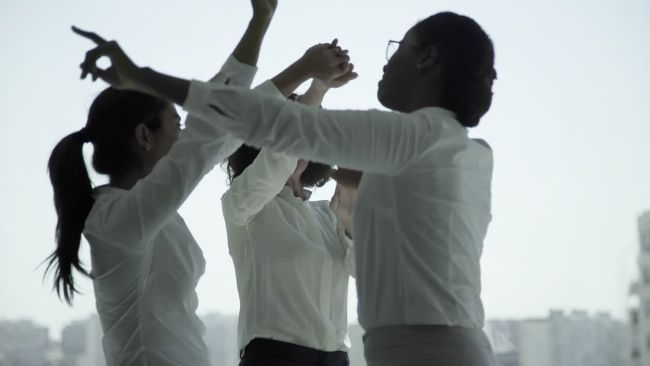 즐거운 다민족 사업가들이 춤을 추고 있습니다.