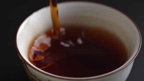 pouring tea into a cup