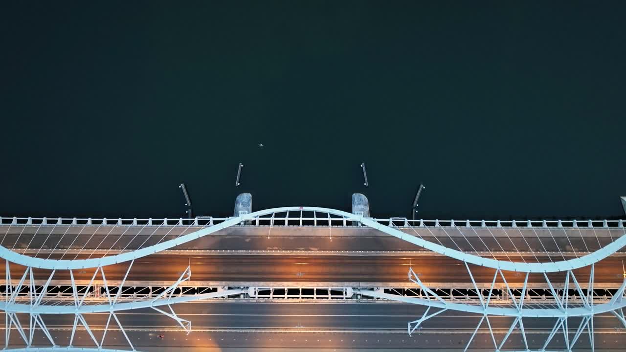 Aerial footage of a modern bridge in Amsterdam, Netherlands at dusk. The bridge is known as Enneüs Heermabrug located to the east of the city connecting several islands