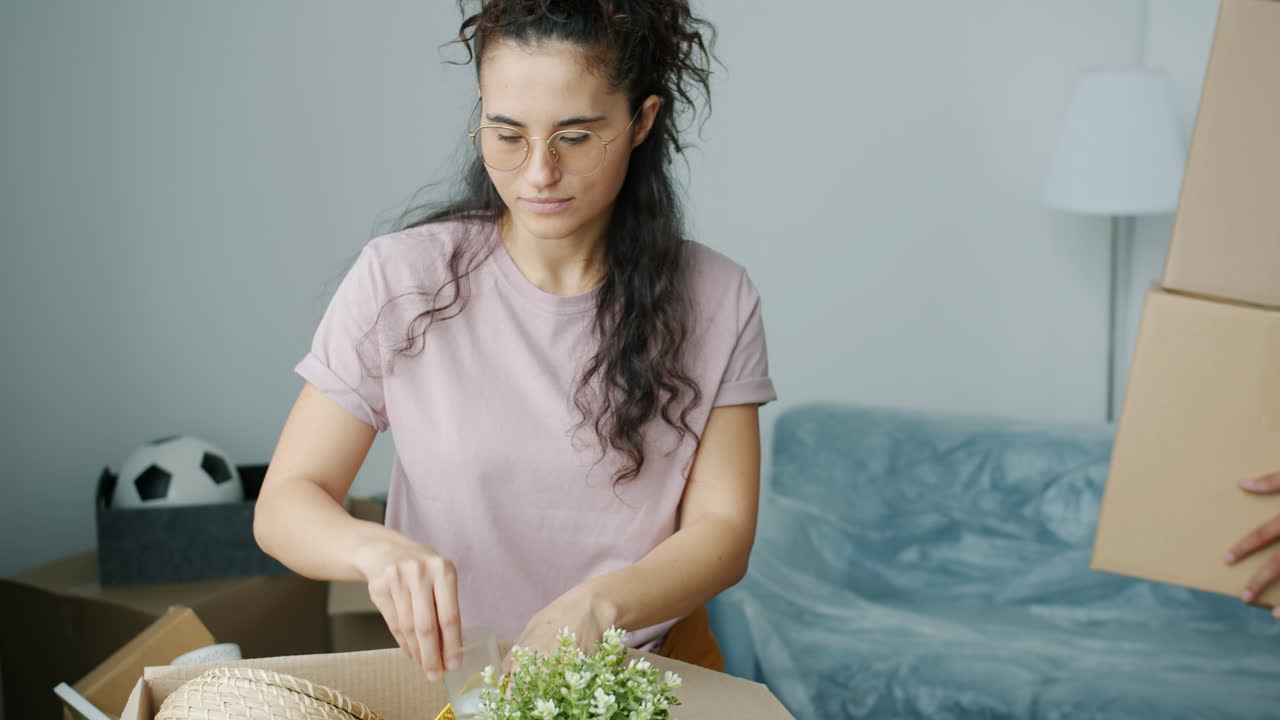 Woman packing boxes during a house move