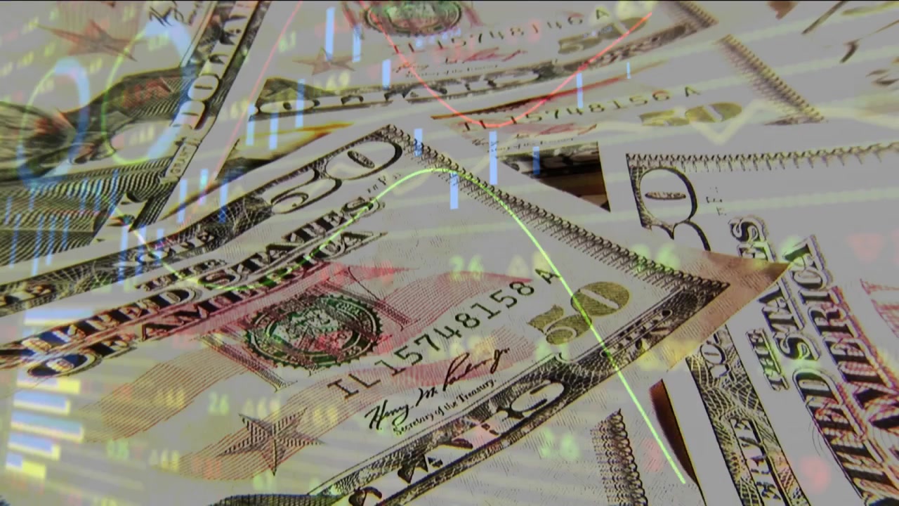 On overlay, US $50 bills shifting and face revealing as market line animating, showing trends
