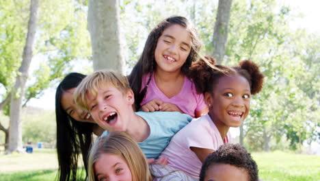 portrait of group of children with friends having fun in park shot in slow motion