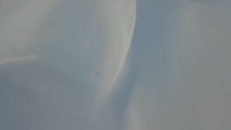 Dramatic-aerial-of-man-hiking-in-snd-dunes-in-South-Africa