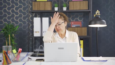 business woman looking scared at laptop.