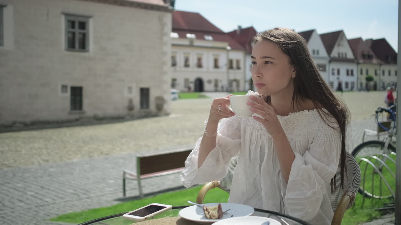 유럽 도시 카페 에서 커피 를 마시고 있는 젊은 여자