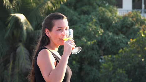 Close-Shot-of-a-Beautiful-Young-Lady-Enjoying-a-Cocktail-on-a-Tropical-Hotel-Rooftop