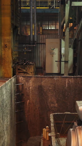 industrial interior of a factory with machinery and large pit