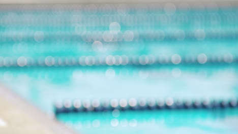 blurred swimming pool with reflection of sunlight in the water