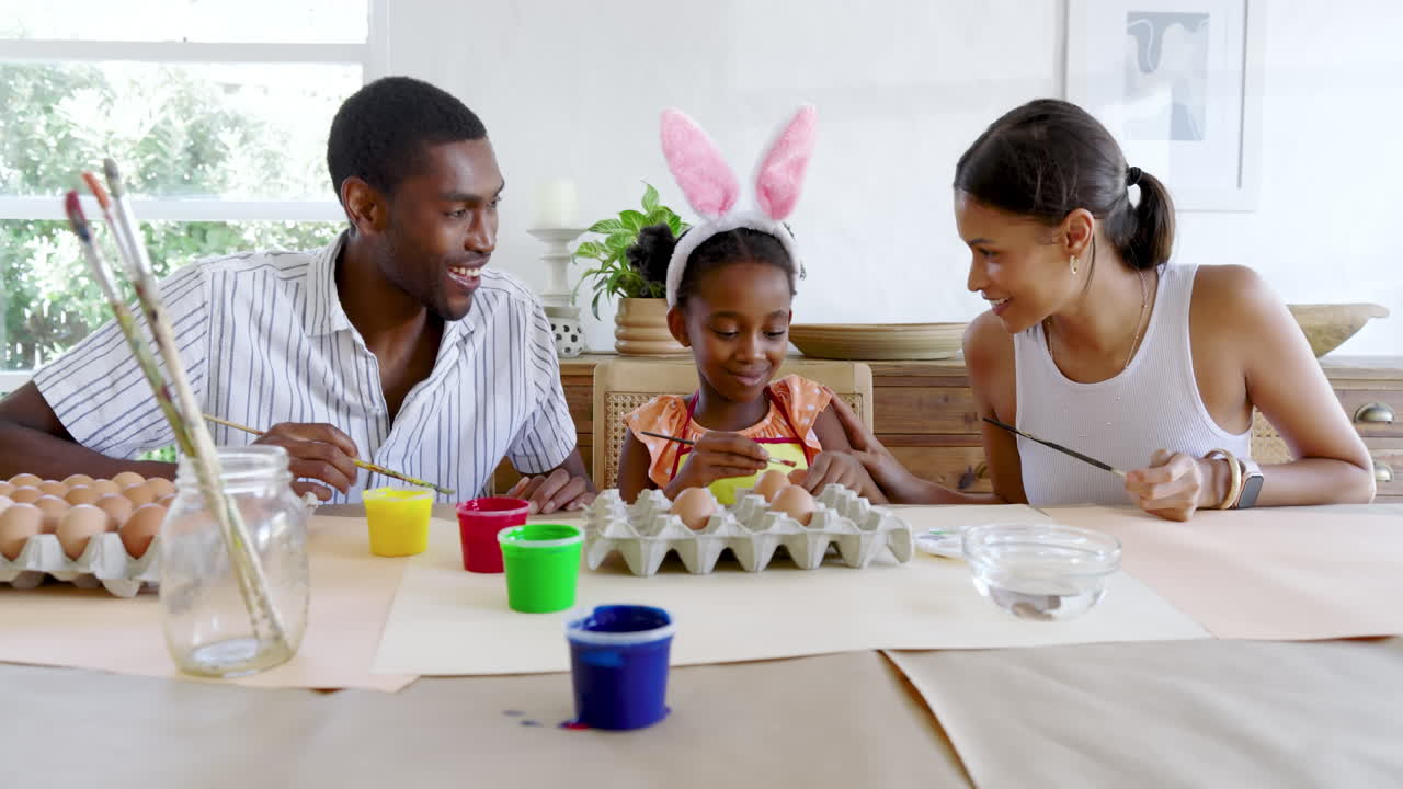 diverse family painting Easter eggs, sharing creative time happily together, at home