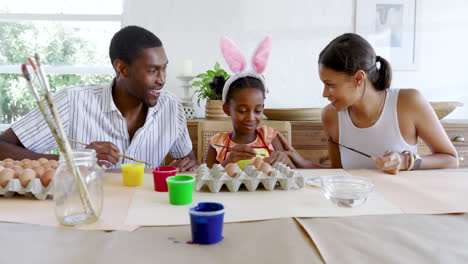 diverse family painting easter eggs, sharing creative time happily together, at home