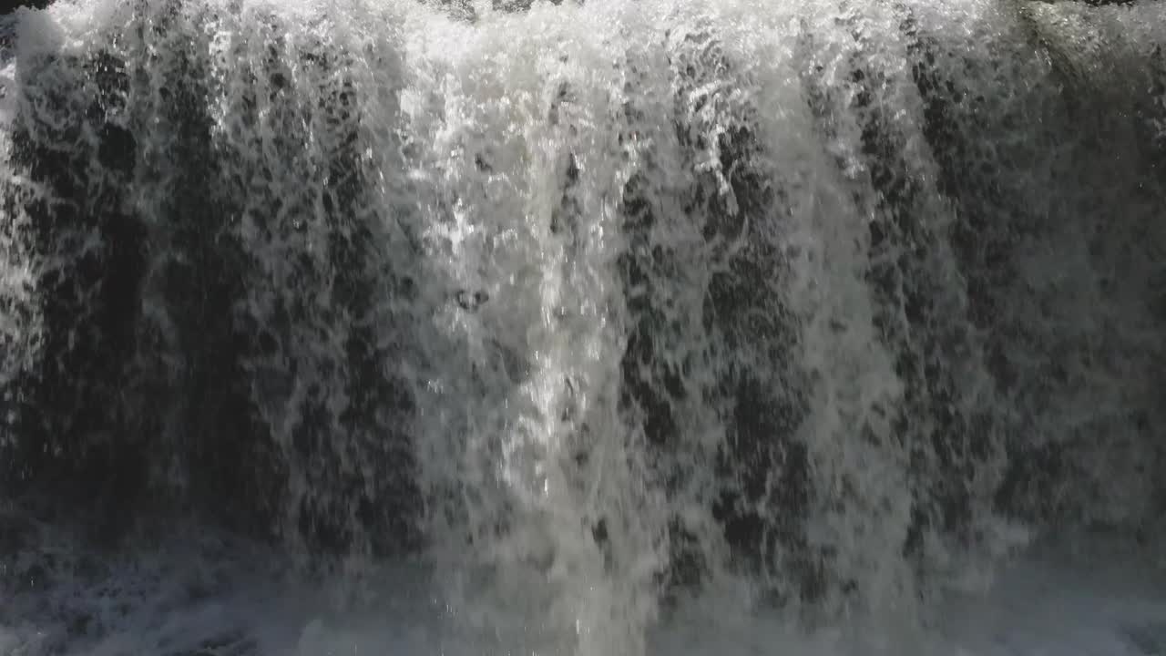 Cascading waterfall in Owen Sound, Canada, lush greenery, summer day, refreshing scene, close-up