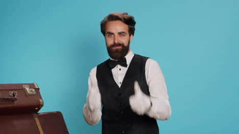 hotel porter gives thumbs up in studio