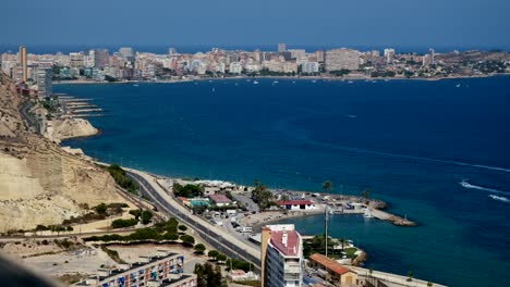 aerial view of alicante city featuring homes living on waterfronts. water activities are seen like boats cruising on blue water.