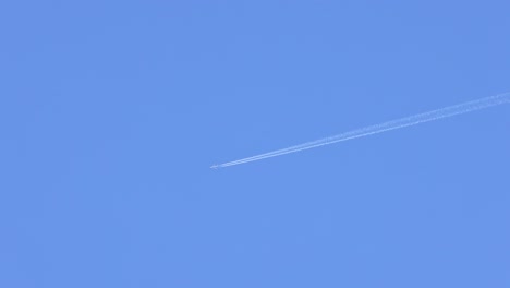 airplane leaving contrail in clear blue sky