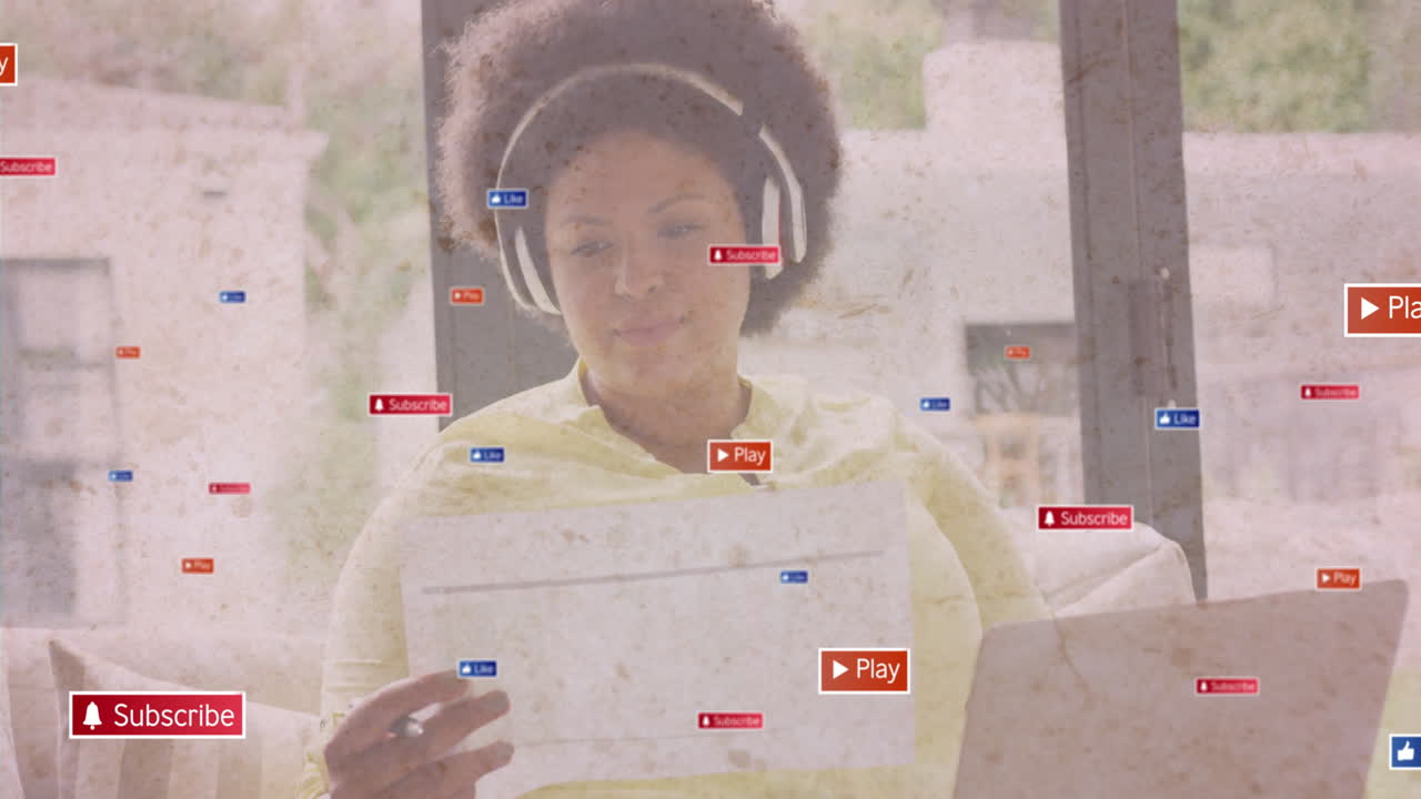 Using tablet with animation of social media icons, person wearing headphones