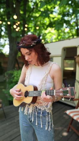 woman playing ukulele outdoors