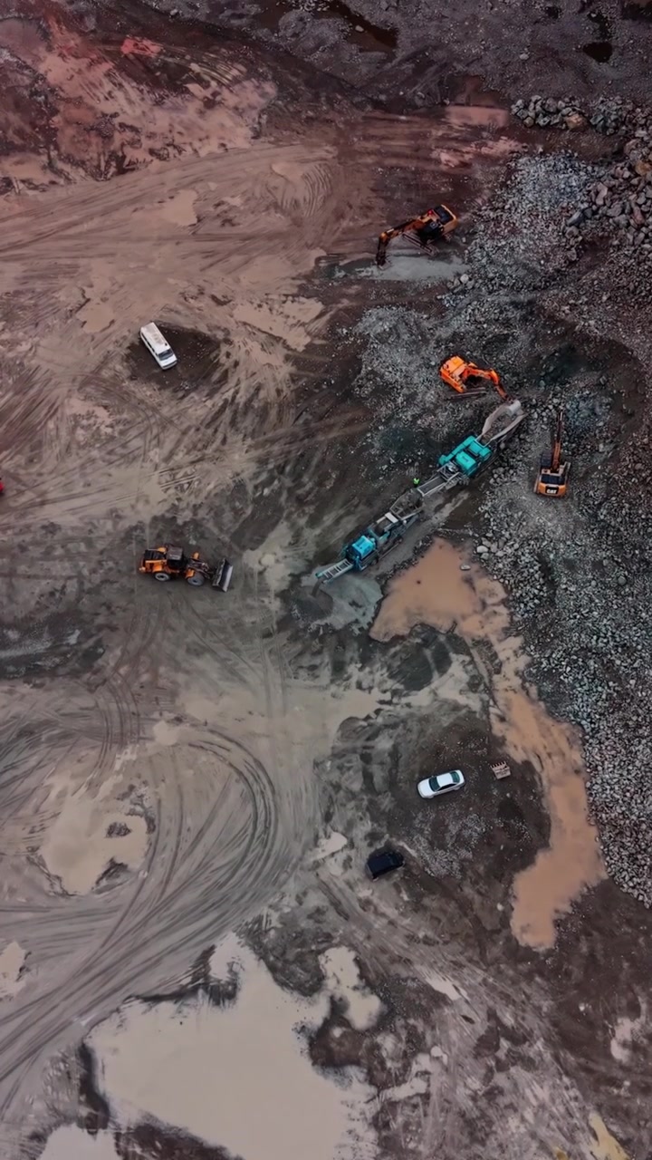 Aerial View of Heavy Machinery and Trucks at an Active Stone Quarry