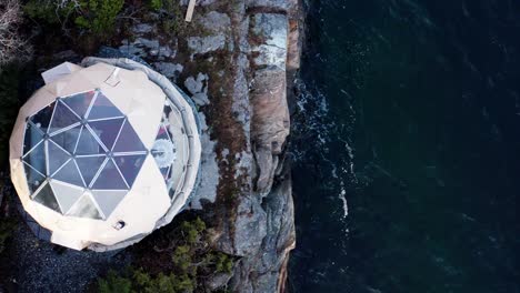 drone ascending at arctic dome - eco camp in the rocky shores of norway