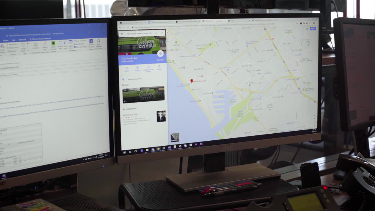 Computer screens displaying maps and websites
