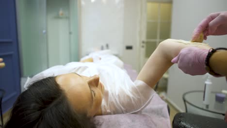 Woman getting waxing treatment at a spa