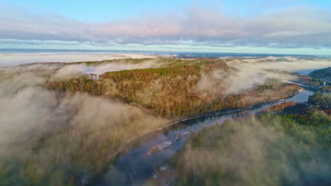 Autumn-morning-fog-over-rivers-and-forests,-seen-by-drones