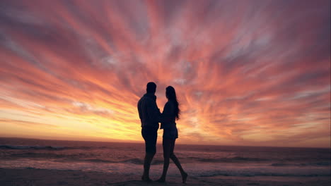 happy couple kissing on beach at sunset silhouette in love dating on honeymoon red dragon