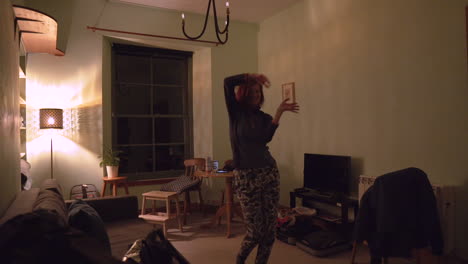 girl dancing in the living room with soft warm light at night time