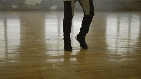 boxer skipping the rope in and empty hall, listen music in headphones in slow motion