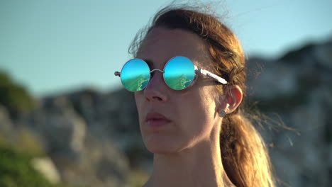 reflection of island peninsula off woman's polarized sunglasses